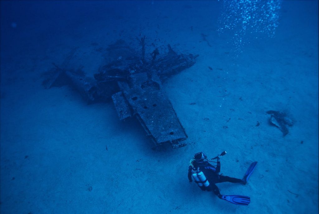 pexels photo 3098969 A scuba diver explores a submerged shipwreck deep underwater, capturing adventure and exploration.